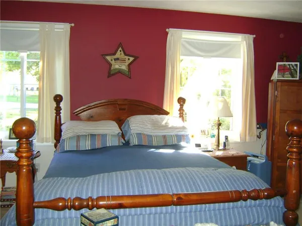 a bed room with a bed and a television