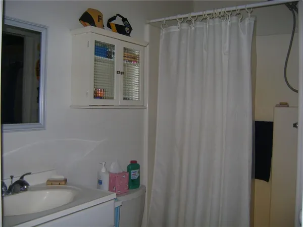 a kitchen with a sink a window and a mirror