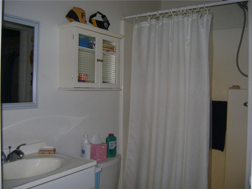 2092 McArthur Road Jamestown, PA 16134 - Photo 24 of 48 a bathroom with a sink a toilet and shower curtain