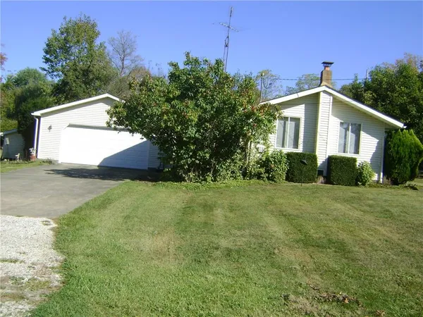 a big house with a big yard and large trees