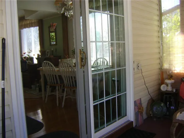 a view of a dining room with furniture and chandelier