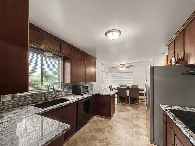 a kitchen with lots of counter top space and stainless steel appliances