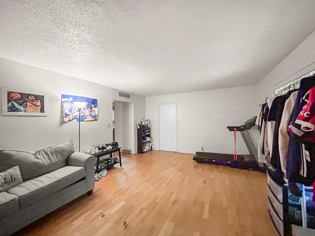 a view of a livingroom with furniture and gym equipment