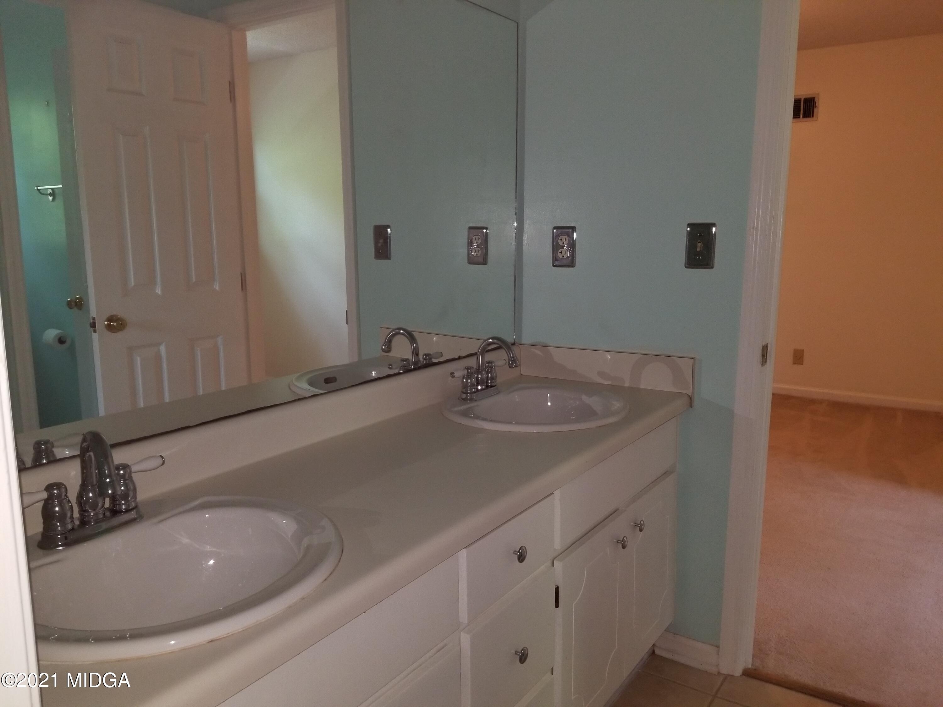 117 Chadwick Drive Macon, GA 31210 - Photo 3 of 8 a bathroom with a sink and a mirror