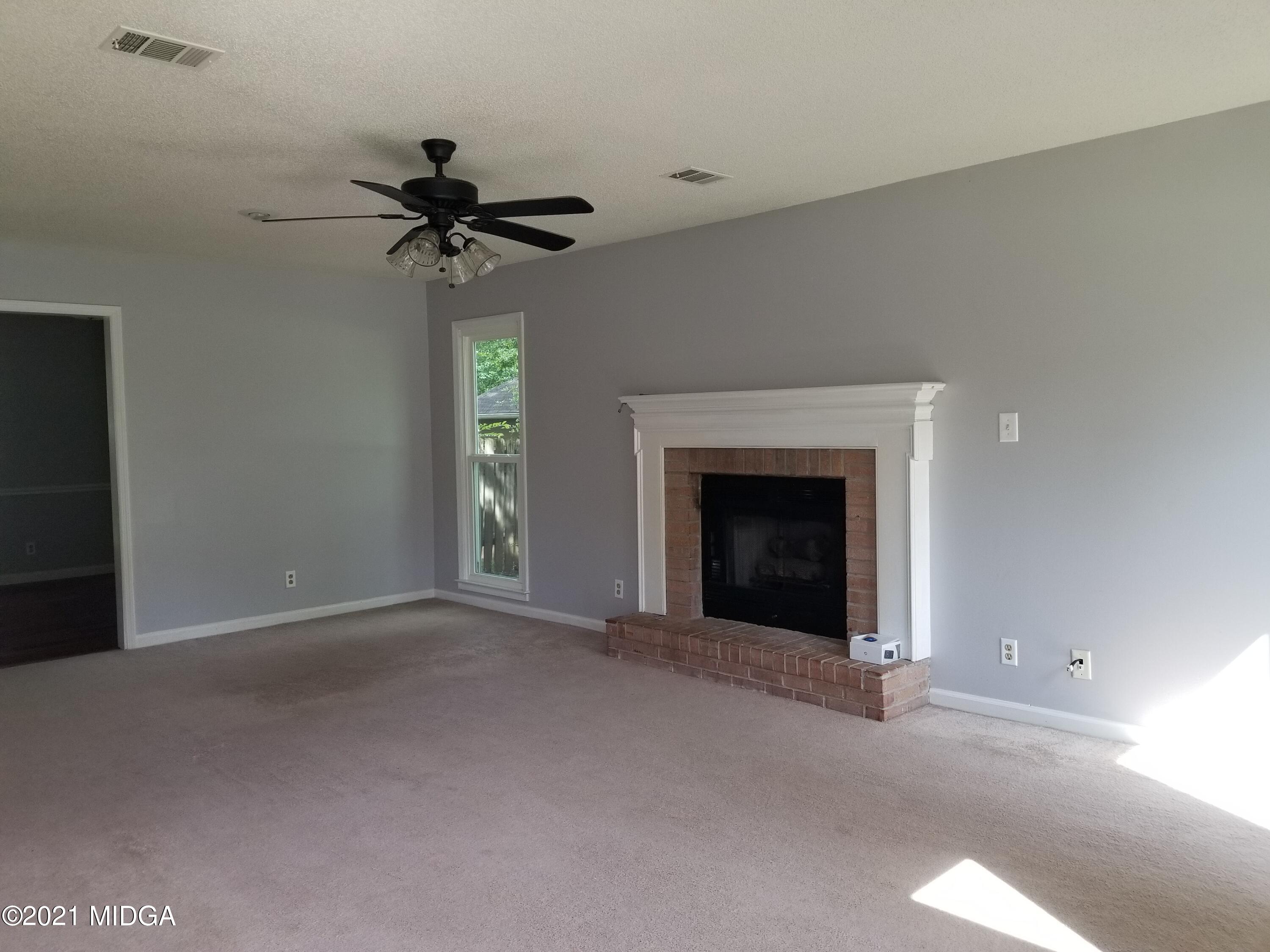 117 Chadwick Drive Macon, GA 31210 - Photo 5 of 8 a view of a livingroom with a ceiling fan and window
