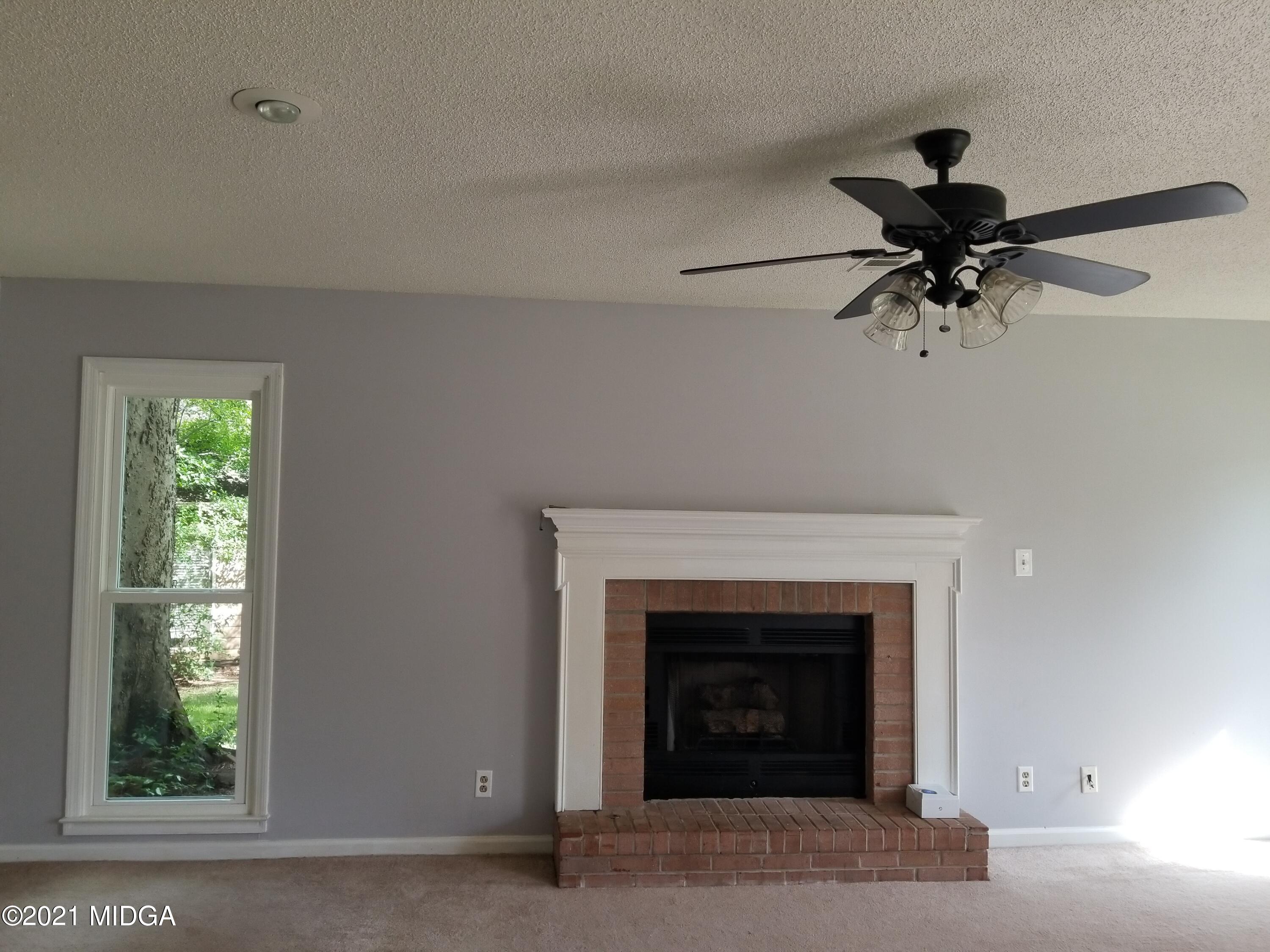 117 Chadwick Drive Macon, GA 31210 - Photo 6 of 8 a living room with furniture and a fireplace