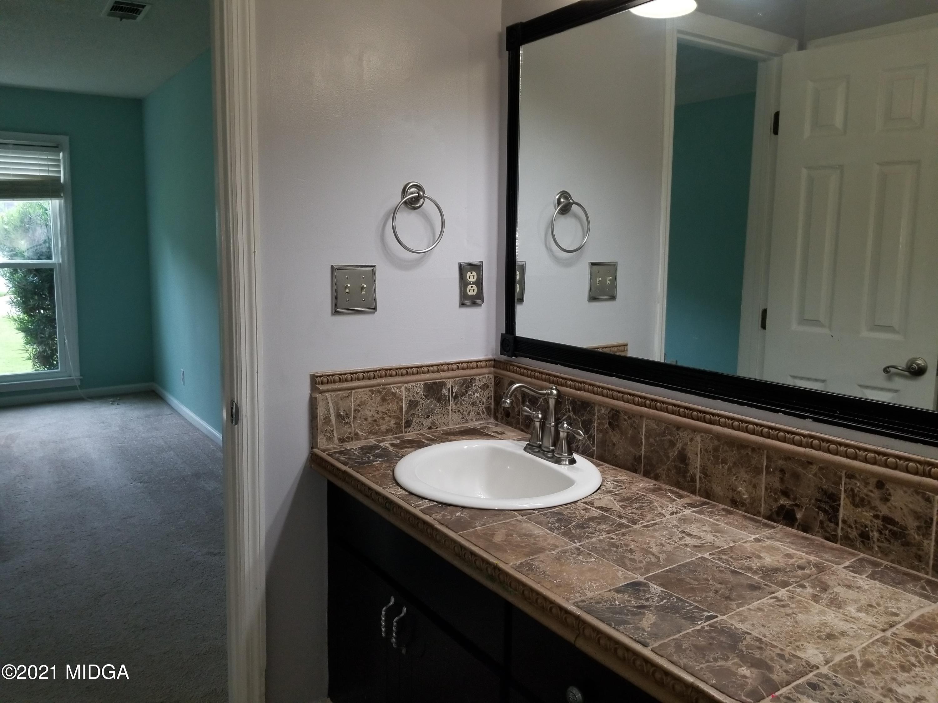 117 Chadwick Drive Macon, GA 31210 - Photo 8 of 8 a bathroom with a sink and a mirror
