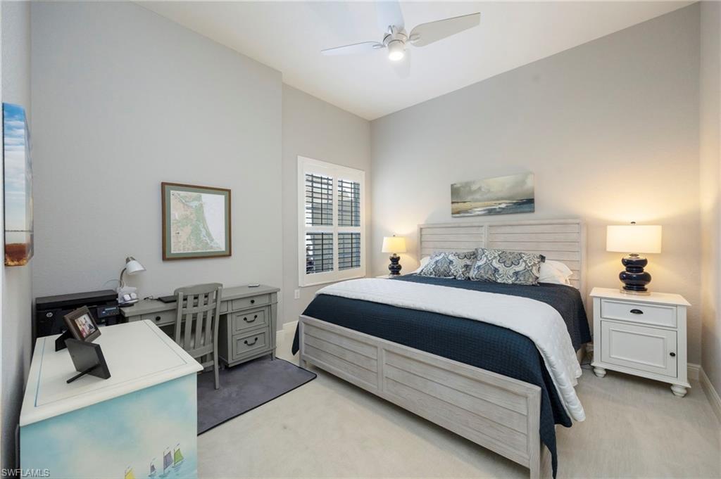 9288 Grassi Way, Unit 102 Naples, FL 34114 - Photo 18 of 37 Bedroom with light carpet, a ceiling fan, and a desk