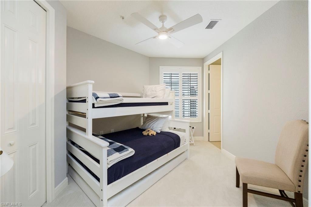 9288 Grassi Way, Unit 102 Naples, FL 34114 - Photo 20 of 37 Bedroom featuring light carpet and ceiling fan