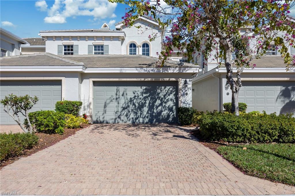 9288 Grassi Way, Unit 102 Naples, FL 34114 - Photo 2 of 37 a front view of a house with garden