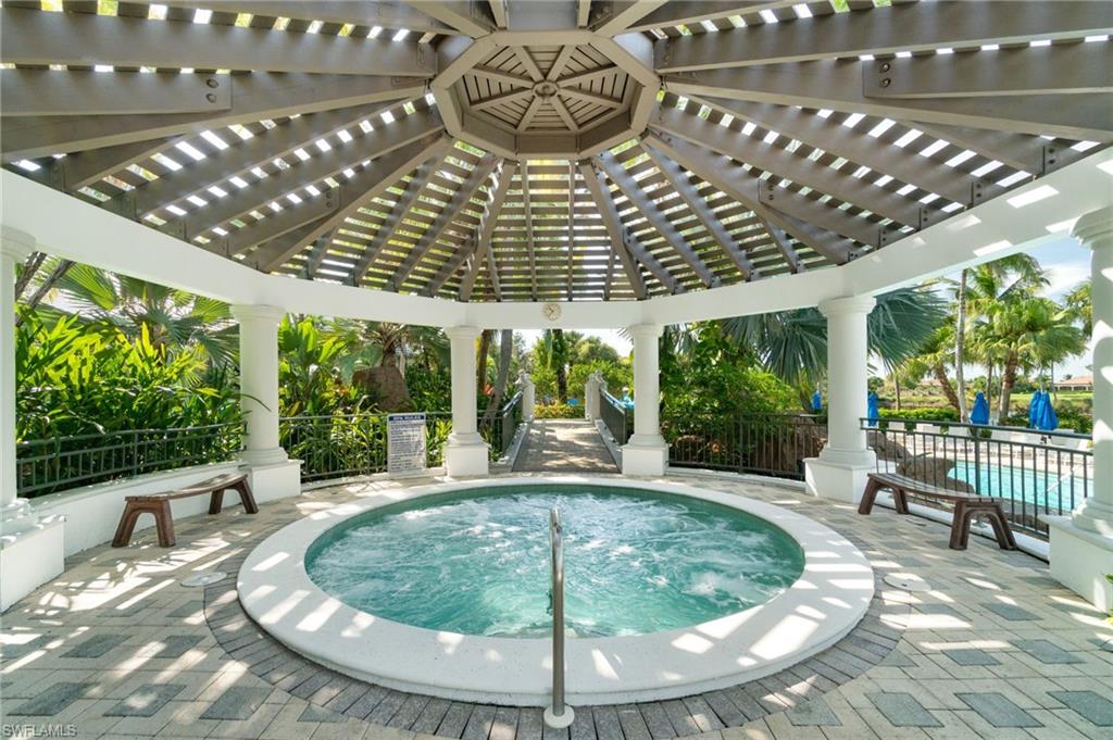 9288 Grassi Way, Unit 102 Naples, FL 34114 - Photo 31 of 37 View of swimming pool featuring a hot tub, a patio, a pergola, and a swimming pool