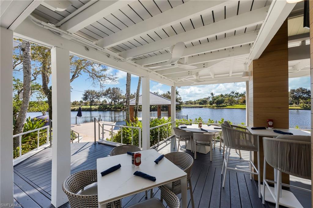 9288 Grassi Way, Unit 102 Naples, FL 34114 - Photo 33 of 37 Deck featuring outdoor dining area and a water view