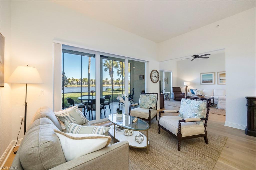 9288 Grassi Way, Unit 102 Naples, FL 34114 - Photo 7 of 37 a living room with furniture and a lamp