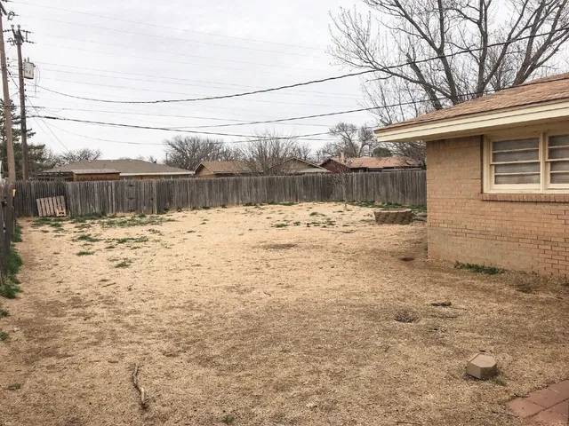 a view of a backyard of the house