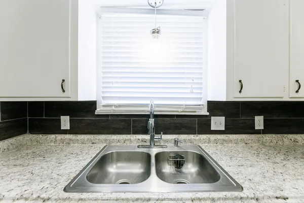 an empty room with a ceiling fan and a window