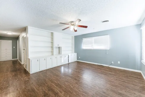 a kitchen with granite countertop a refrigerator stove top oven and sink