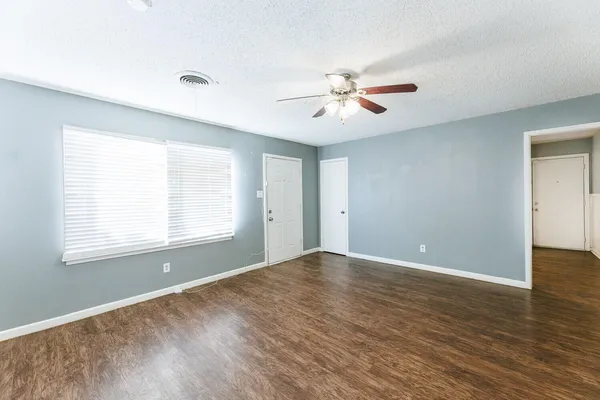 a kitchen with granite countertop white cabinets sink and stainless steel appliances