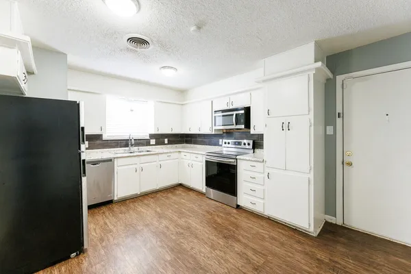a stove top oven sitting inside of a kitchen