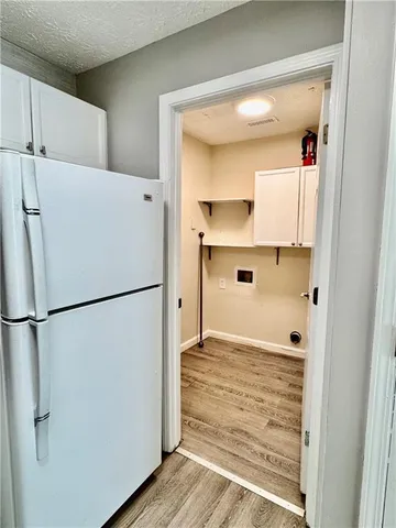 a white refrigerator freezer sitting in a kitchen