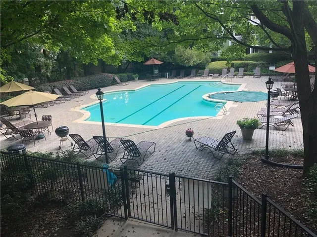 a view of a park with iron fence