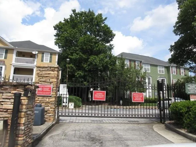 a view of sign board with a small yard