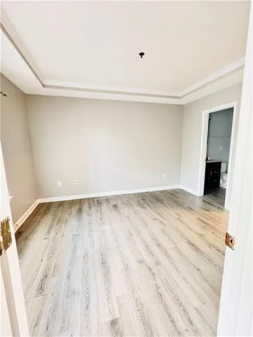 a view of a room with wooden floor