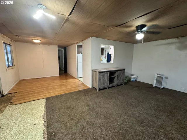 a view of a livingroom with furniture and a window