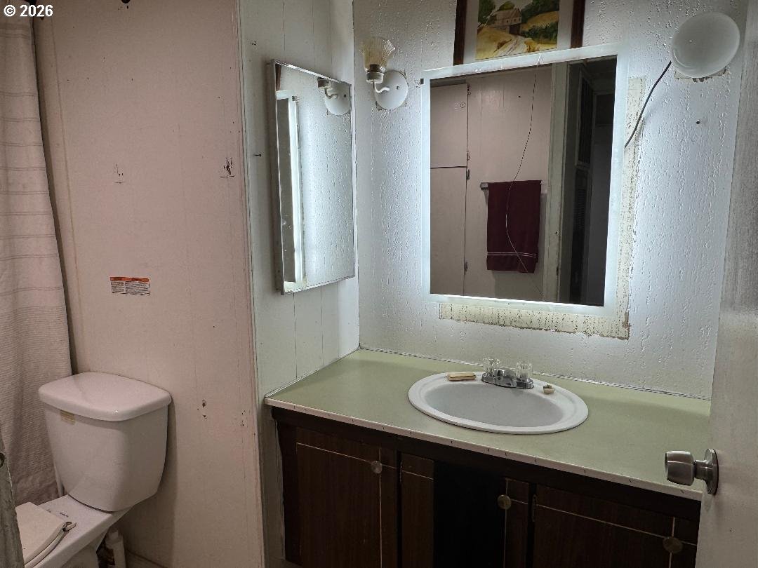 5000 Northeast Stephens Street, Unit 2 Roseburg, OR 97470 - Photo 5 of 23 a bathroom with a sink toilet and mirror