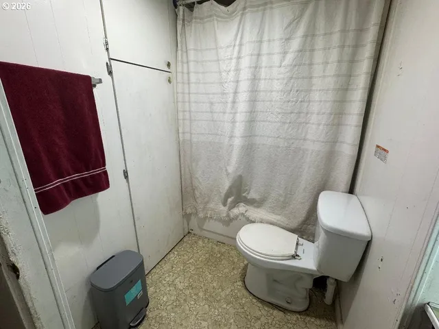 a bathroom with a toilet and a shower