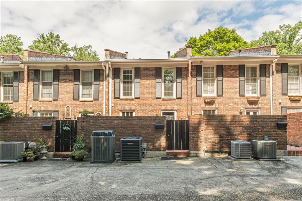 320 Alberta Terrace Northeast, Unit 3 Atlanta, GA 30305 - Photo 11 of 54 a front view of a house with a yard