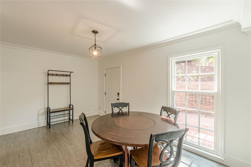320 Alberta Terrace Northeast, Unit 3 Atlanta, GA 30305 - Photo 15 of 54 a view of a dining room with furniture window and wooden floor