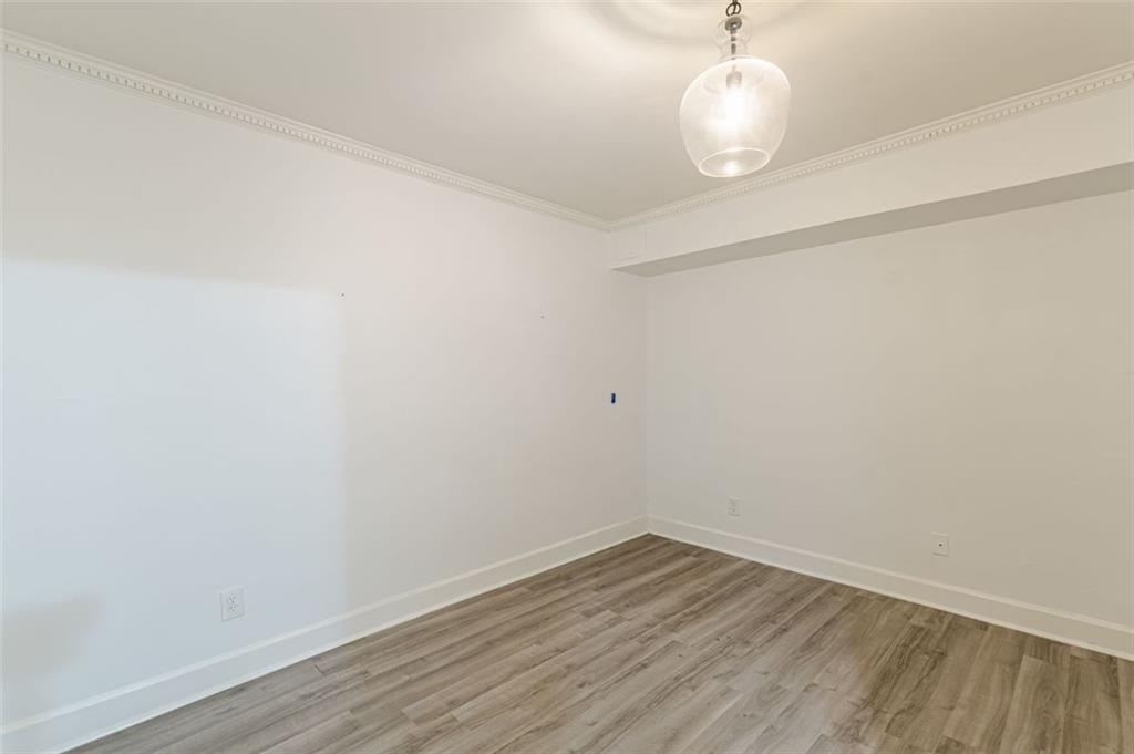 320 Alberta Terrace Northeast, Unit 3 Atlanta, GA 30305 - Photo 31 of 54 a view of a room with wooden floor and white walls