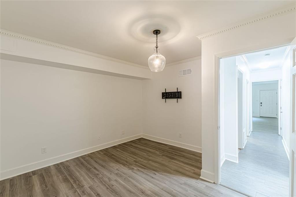 320 Alberta Terrace Northeast, Unit 3 Atlanta, GA 30305 - Photo 32 of 54 a view of a room with wooden floor and a ceiling fan