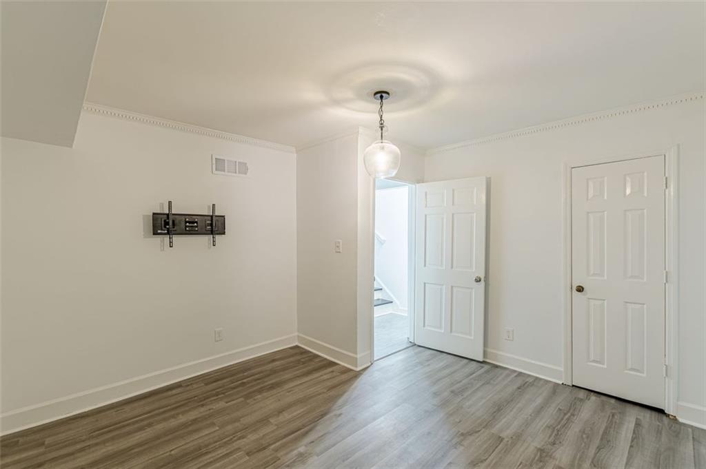 320 Alberta Terrace Northeast, Unit 3 Atlanta, GA 30305 - Photo 33 of 54 an empty room with wooden floor and windows