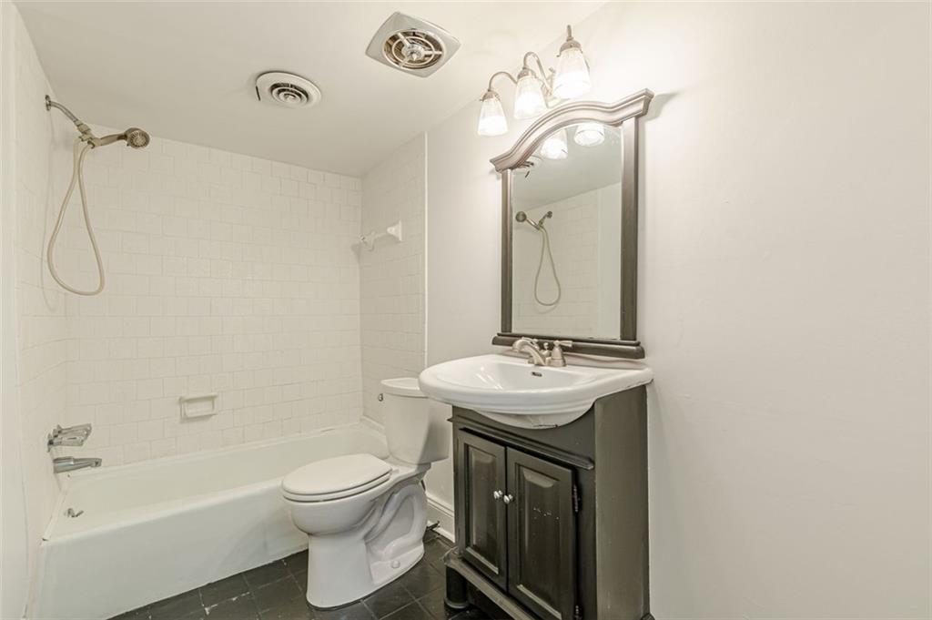 320 Alberta Terrace Northeast, Unit 3 Atlanta, GA 30305 - Photo 35 of 54 a bathroom with a sink a toilet and shower