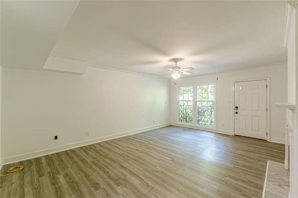 320 Alberta Terrace Northeast, Unit 3 Atlanta, GA 30305 - Photo 36 of 54 a view of an empty room with wooden floor and a window