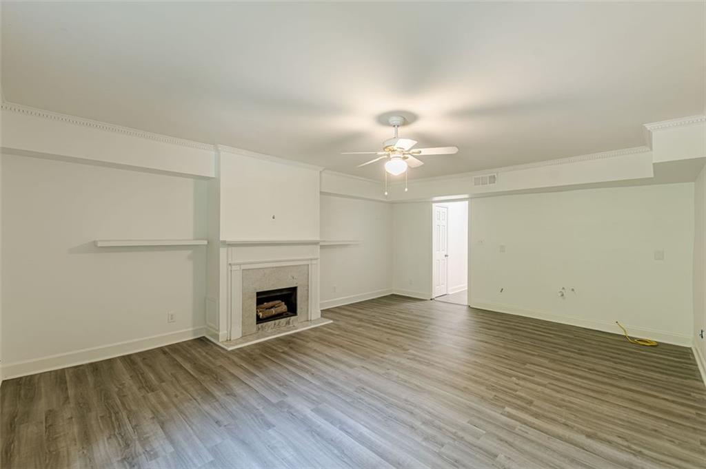 320 Alberta Terrace Northeast, Unit 3 Atlanta, GA 30305 - Photo 38 of 54 an empty room with wooden floor fireplace and windows