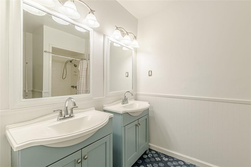 320 Alberta Terrace Northeast, Unit 3 Atlanta, GA 30305 - Photo 53 of 54 a bathroom with a sink and a mirror