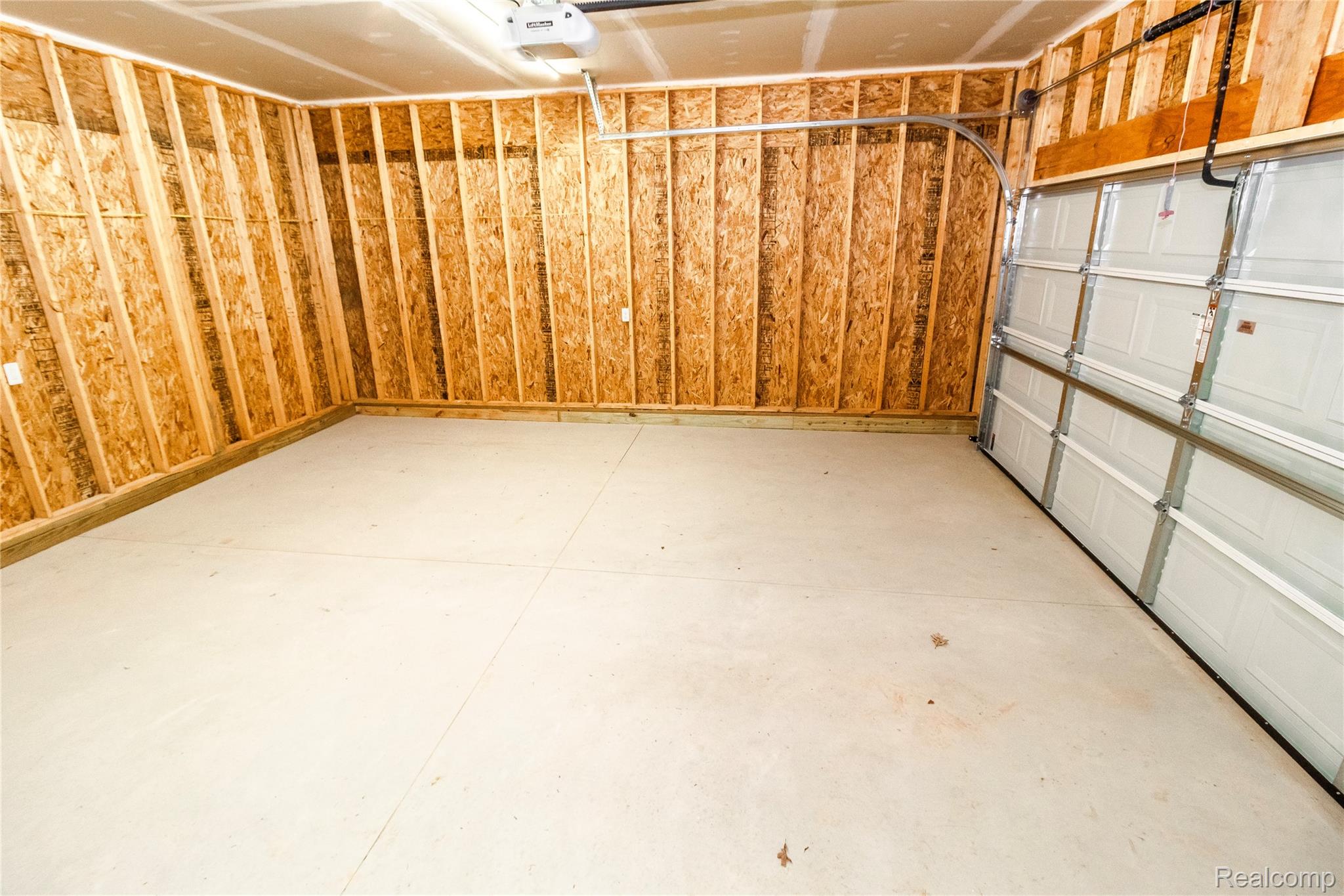5155 Coldwater Road Lapeer, MI 48446 - Photo 21 of 24 Garage featuring a garage door opener