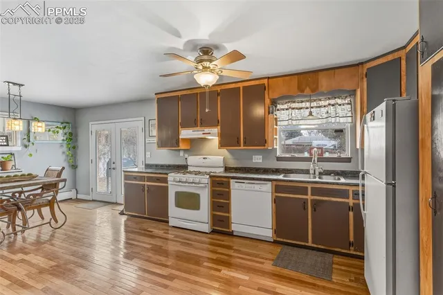 a kitchen with stainless steel appliances granite countertop a stove and refrigerator