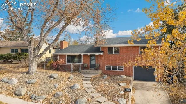 a view of a house with a yard covered in snow