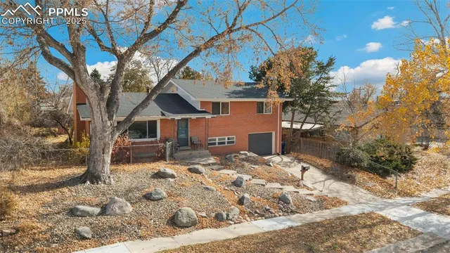 a view of a house with a yard covered in snow