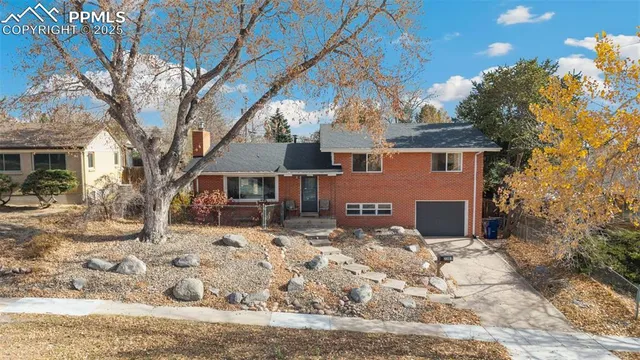 a front view of a house with a yard covered in snow