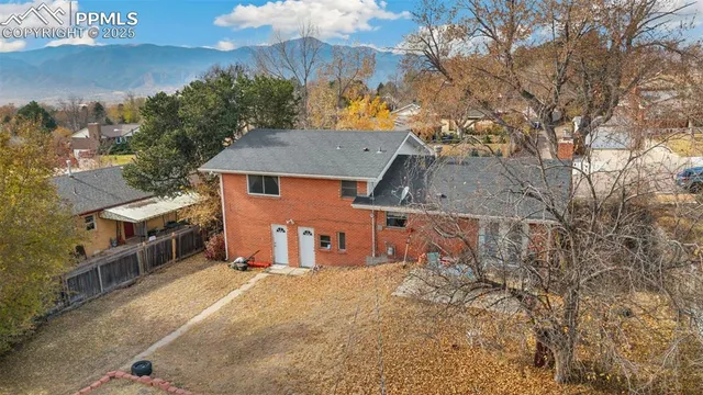 an aerial view of a house with a yard and sitting area