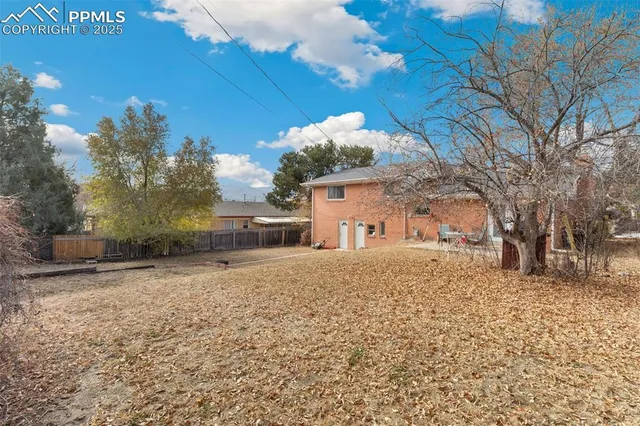 a backyard of a house with large trees