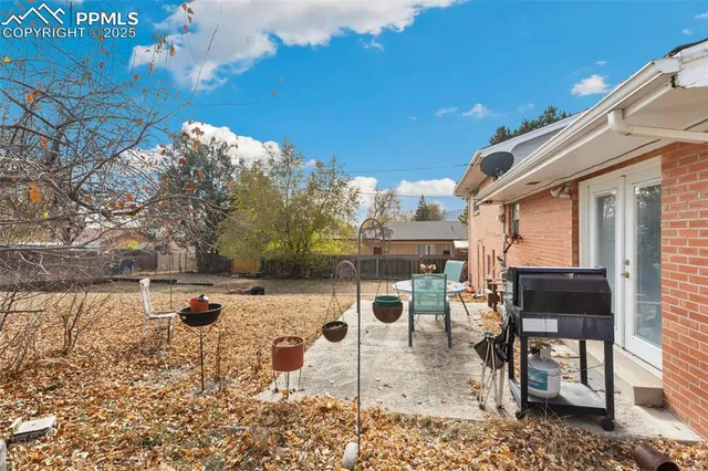 a backyard of a house with table and chairs