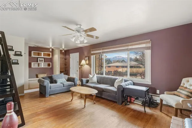 a living room with furniture a rug and a large window