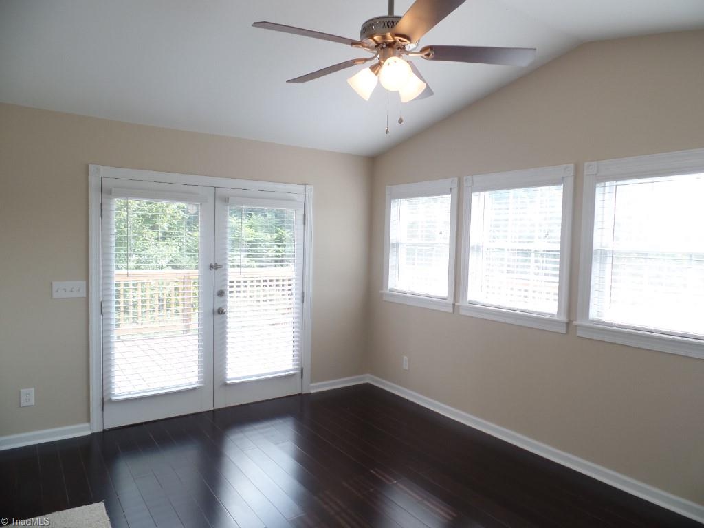 1939 Bloomtown Road East Bend, NC 27018 - Photo 14 of 26 Sunroom/formal dining room with atrium doors look out onto deck. Check out those beautiful floors.