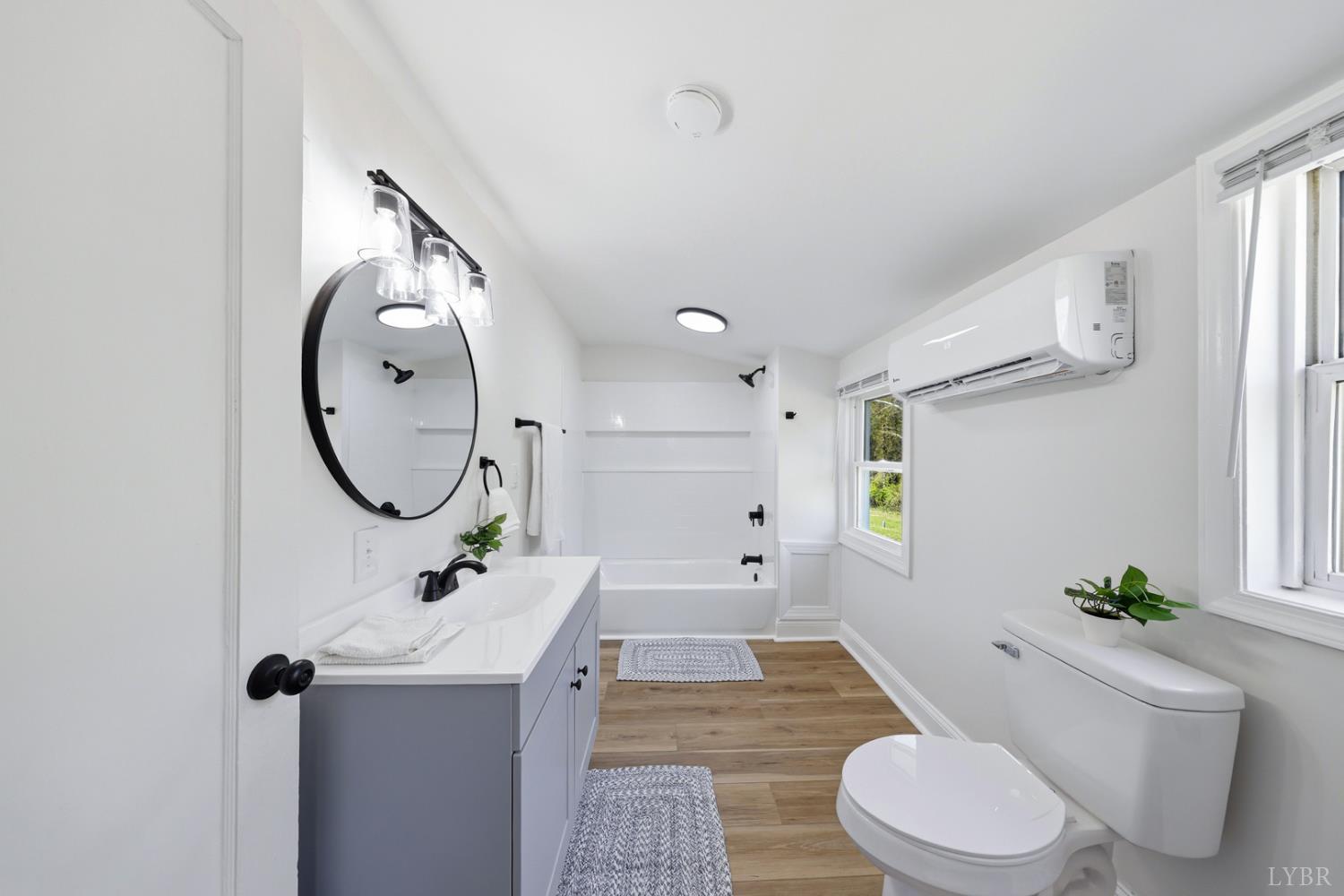 1410 Lynch Road Altavista, VA 24517 - Photo 15 of 34 a bathroom with a sink a toilet and a mirror