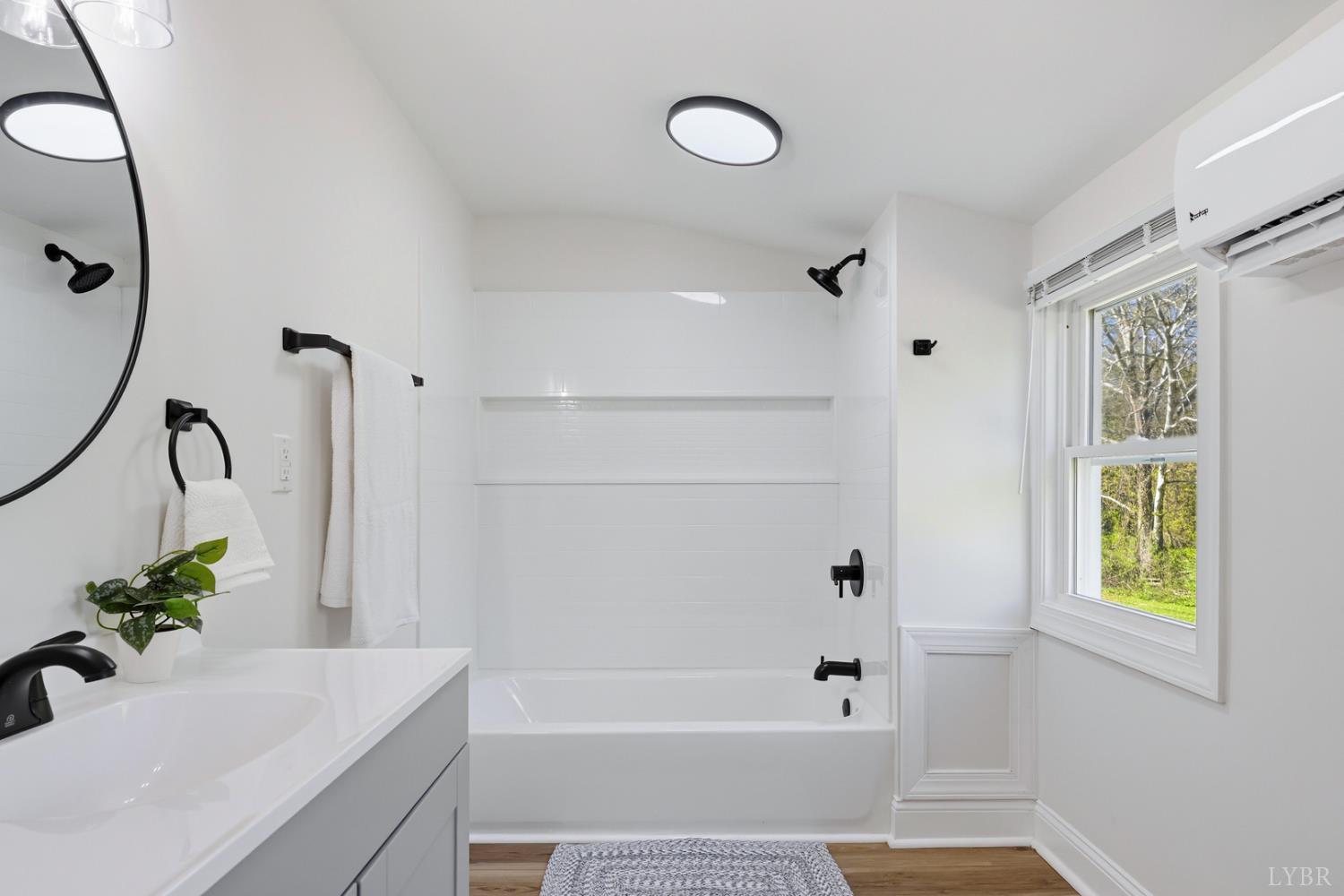 1410 Lynch Road Altavista, VA 24517 - Photo 16 of 34 a bathroom with a bathtub sink and mirror